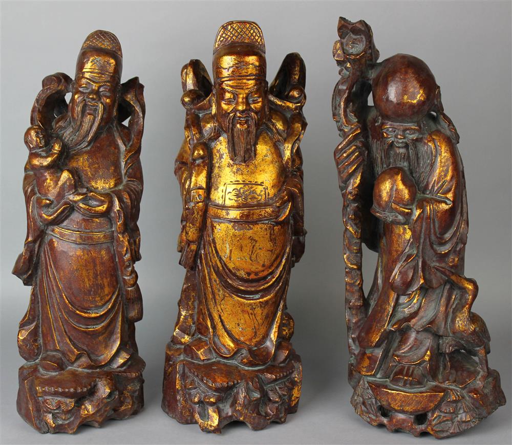 Appraisal: THREE CHINESE GILTWOOD FIGURES OF IMMORTALS MODERN each dressed in