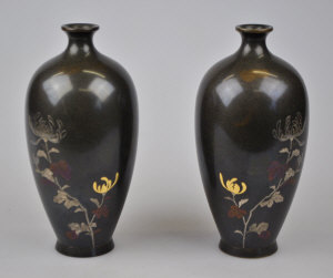 Appraisal: A pair of Japanese bronze vases inlaid in gold silver