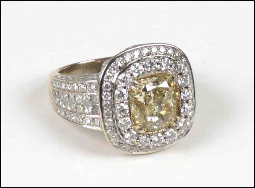 Appraisal: DIAMOND AND KARAT GOLD RING Central cushion cut yellow diamond