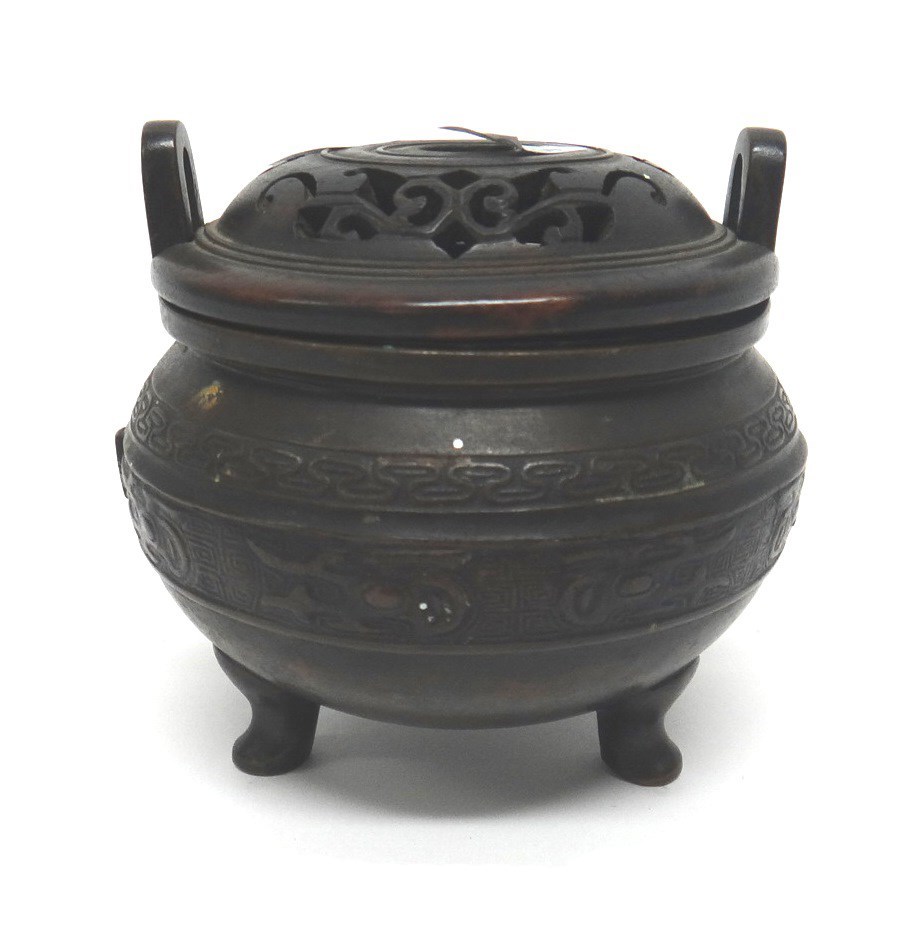 Appraisal: A small Chinese bronze tripod censer and pierced wood cover