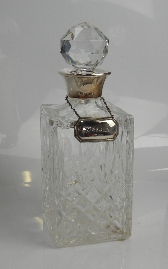 Appraisal: A square cut glass spirit decanter with silver mounts and