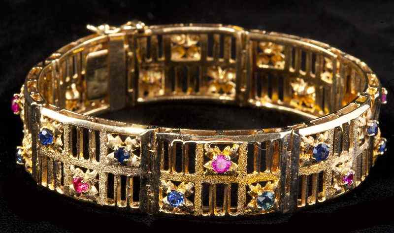 Appraisal: Gold Sapphire and Ruby Link Braceletdesigned of open carved rectangular