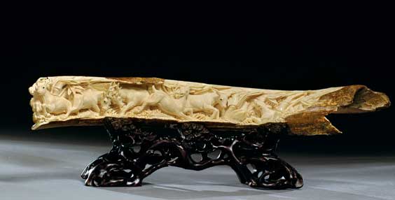 Appraisal: FOSSIL IVORY TUSK WITH DEER Beautifully carved in high relief