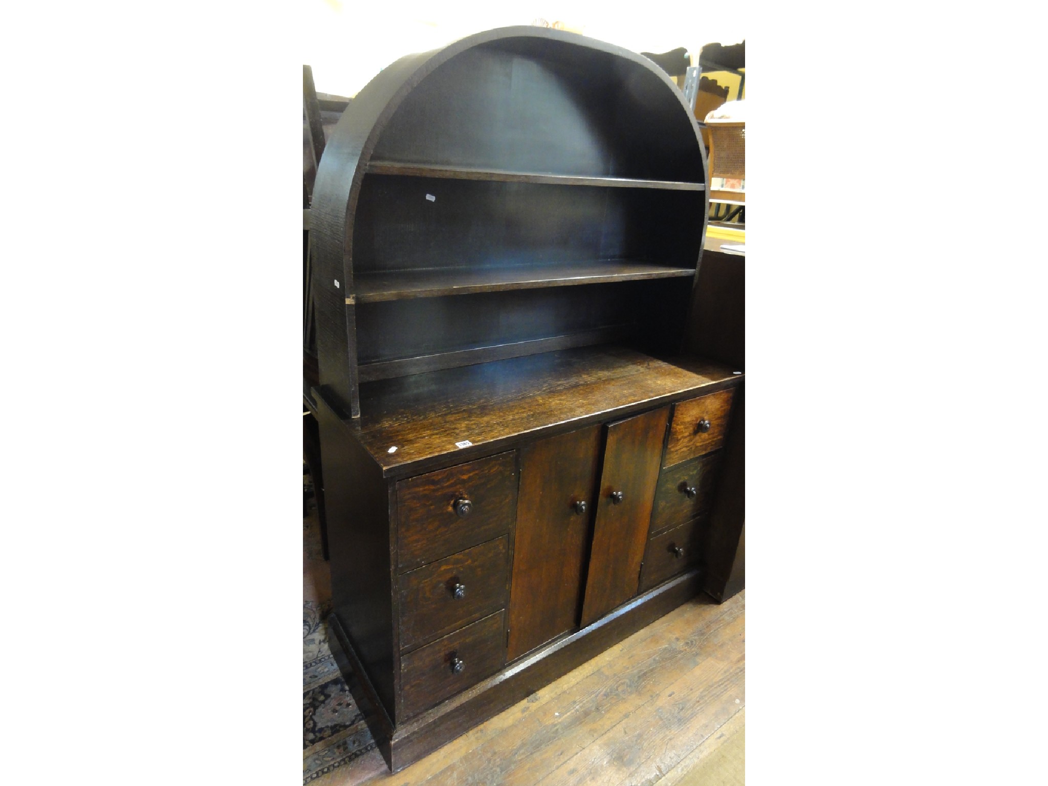 Appraisal: An dark stained oak cottage dresser the recessed dome top