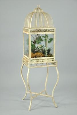 Appraisal: A Petite Terrarium A wrought metal and glass terrarium on