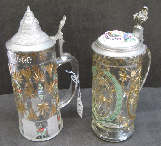 Appraisal: TWO GERMAN DECORATED BEER STEINS L size One with a