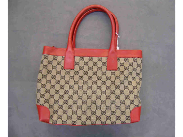 Appraisal: Gucci handbag monogrammed fabric with black lettering red leather trim