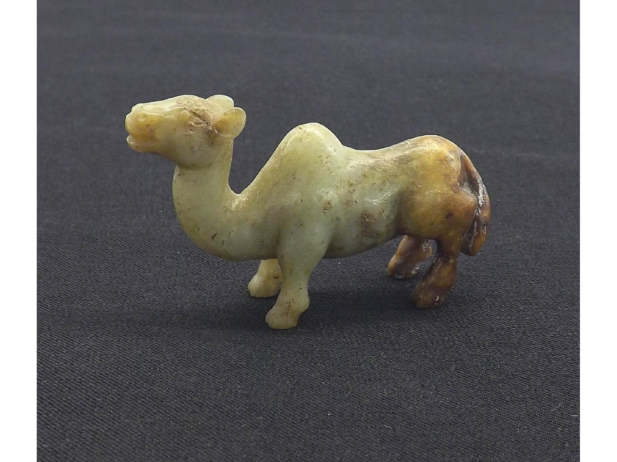 Appraisal: Celadon and brown carved jade modelled as a camel