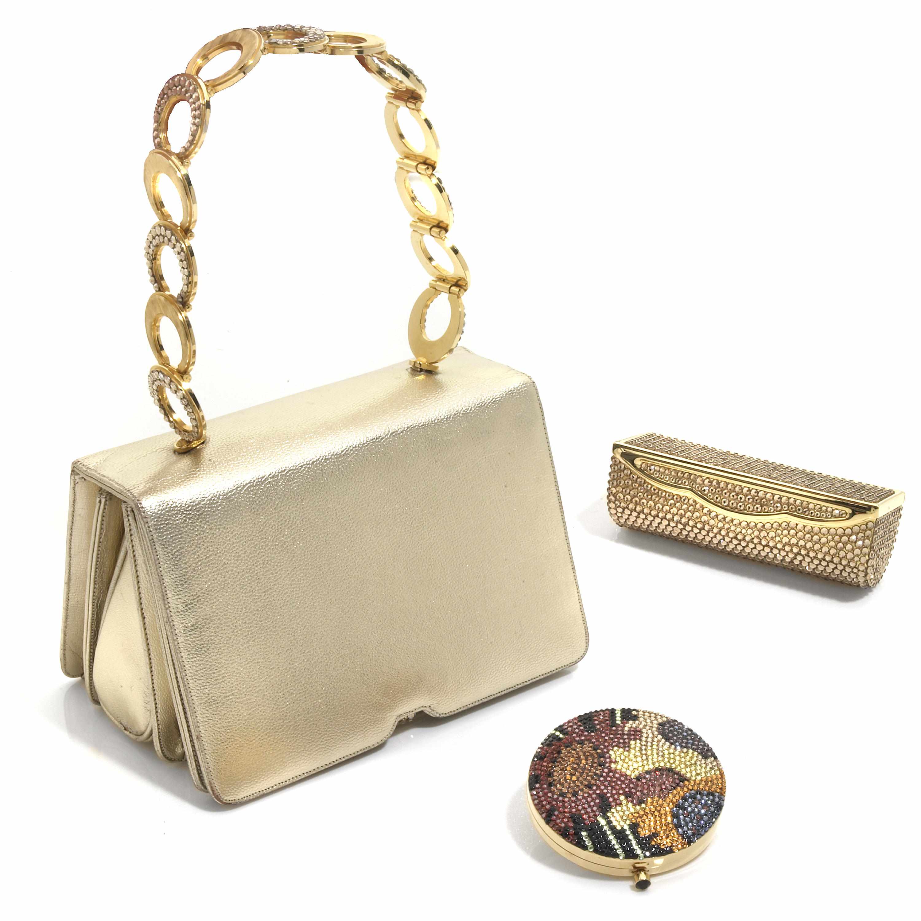 Appraisal: A gold colored leather and metal purse with a silver