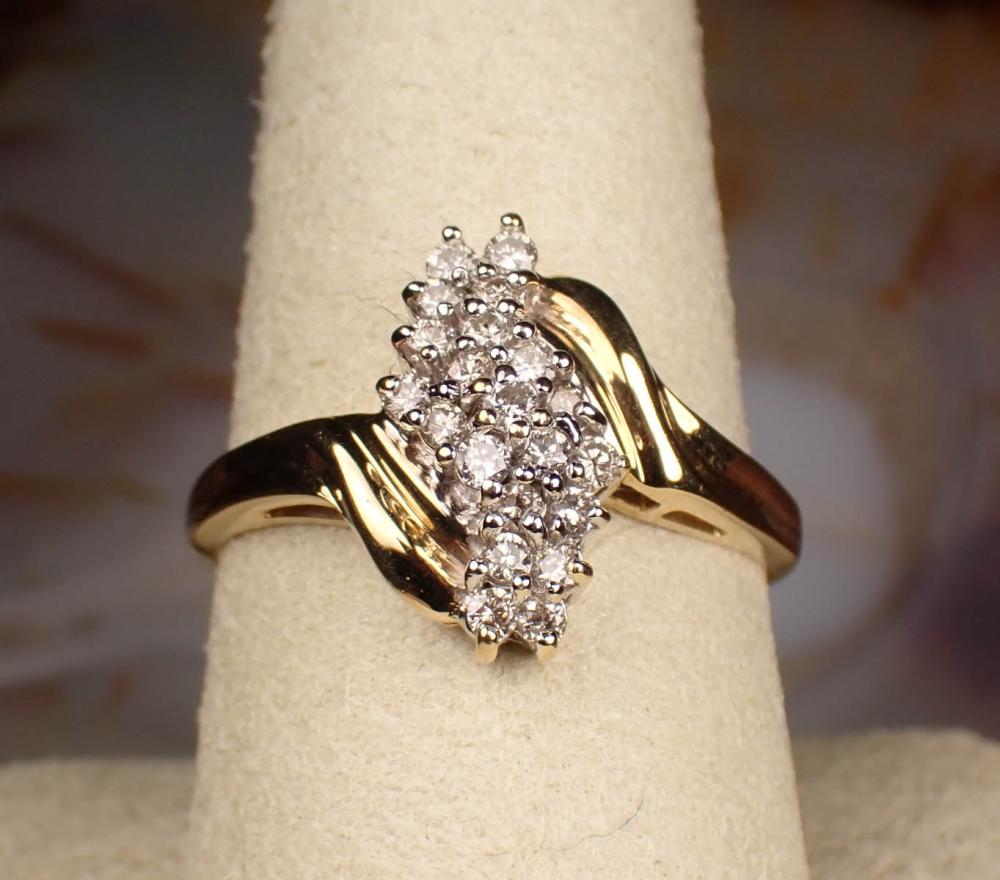 Appraisal: DIAMOND AND FOURTEEN KARAT GOLD CLUSTER RING The yellow and