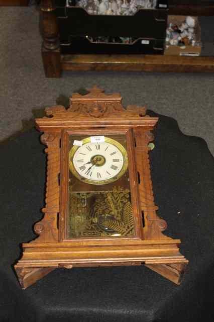 Appraisal: AN AMERICAN OAK MANTEL CLOCK with shaped case and two