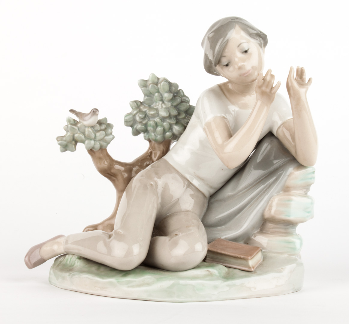 Appraisal: Lladro porcelain figure young boy laying against rock playing flute