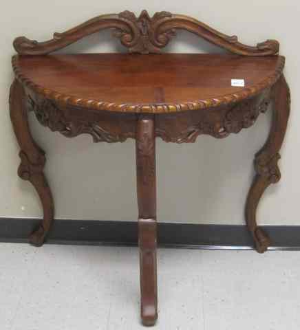 Appraisal: CARVED MAHOGANY CONSOLE TABLE AND WALL MIRROR Rococo Revival design