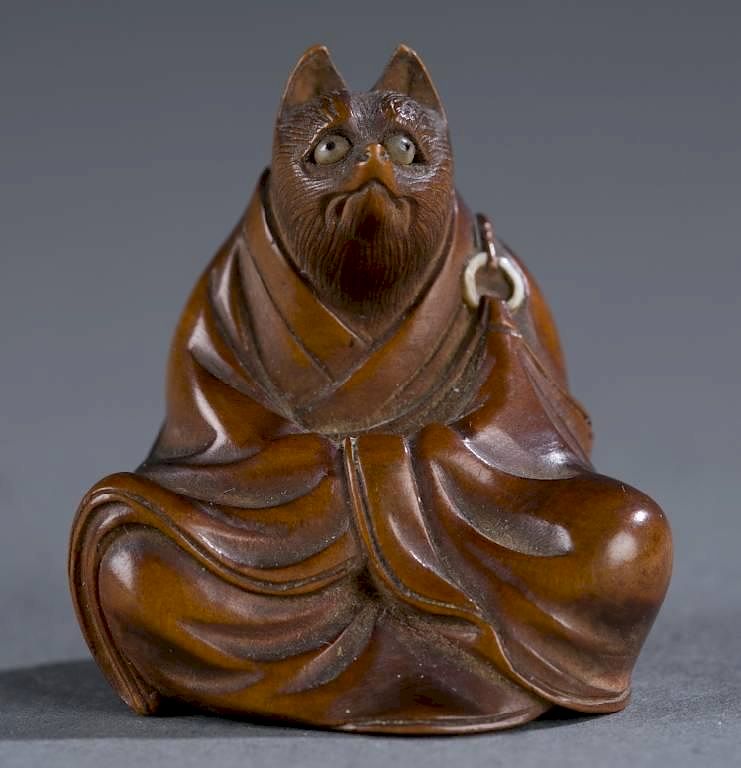 Appraisal: Japanese wood netsuke of seated tanuki A Japanese wood netsuke