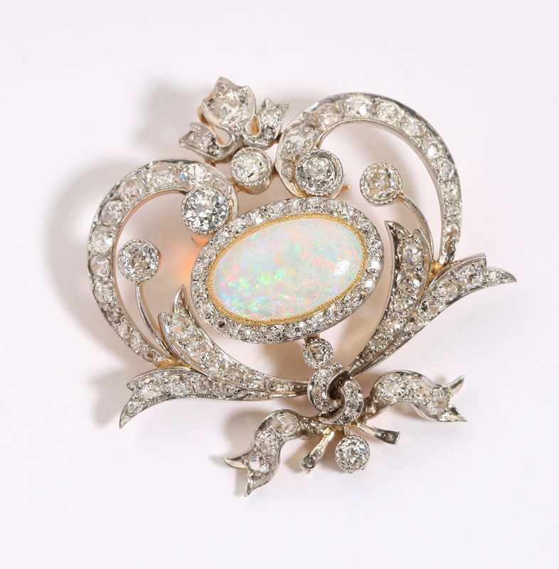 Appraisal: Circa platinum-topped yellow gold centering an oval cabochon opal measuring