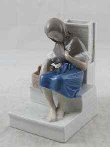 Appraisal: A Royal Copenhagen ceramic model of a girl asleep with