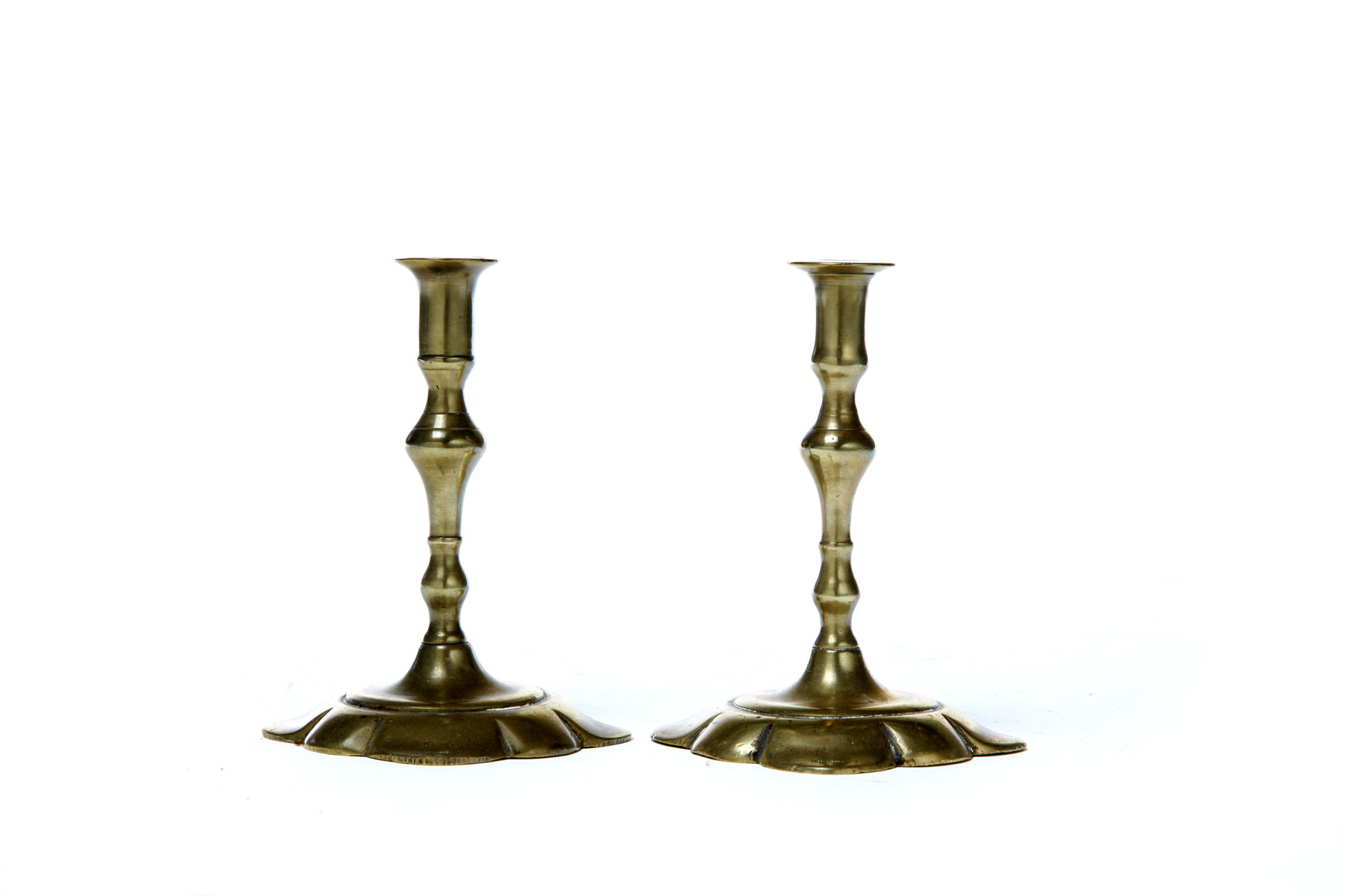 Appraisal: PAIR OF BRASS TAPERSTICKS England mid th century Petal bases