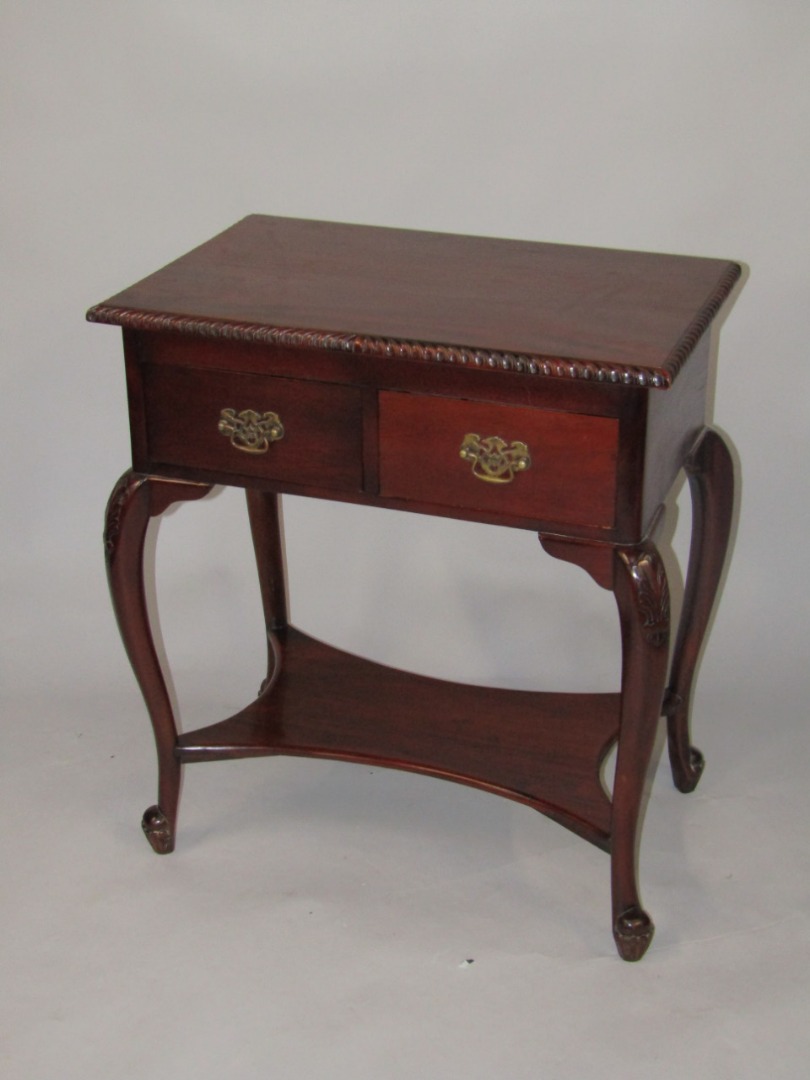 Appraisal: A hardwood side table the rectangular top with a carved