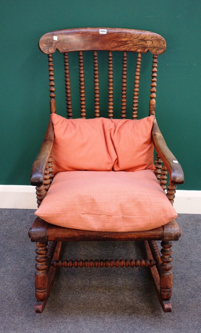 Appraisal: A Victorian faux rosewood rocking chair with bobbin turned decoration