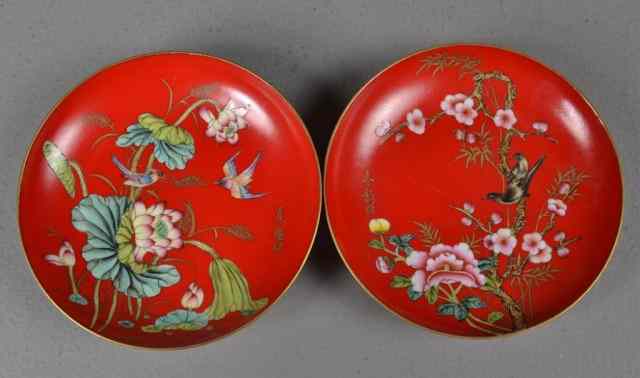 Appraisal: Pair Chinese Red Saucers with DecorationPair of red glazed porcelain