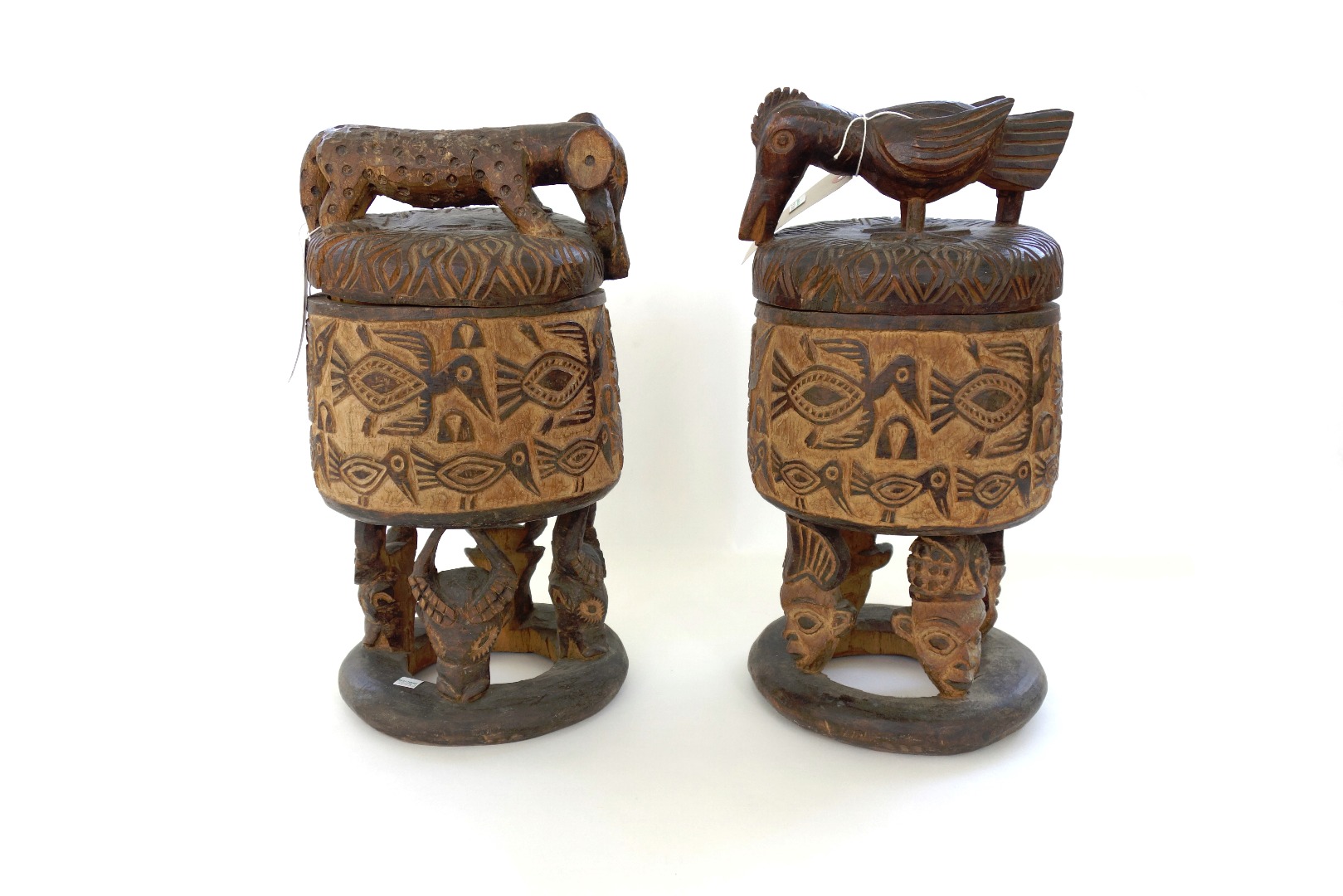 Appraisal: A pair of carved wooden covered pots Grasslands style Cameroon