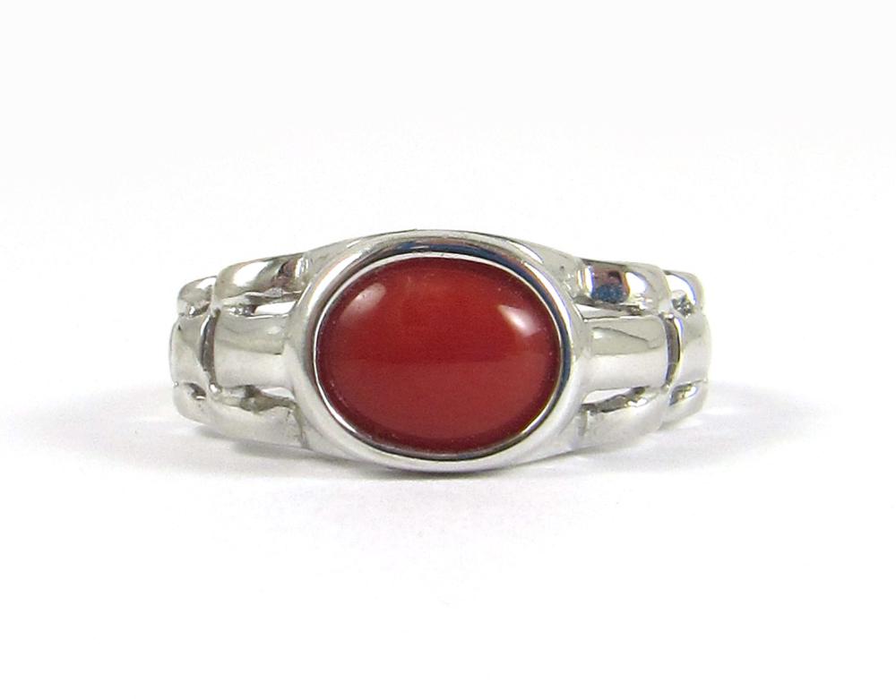 Appraisal: CORAL AND FOURTEEN KARAT WHITE GOLD RING with a Rolex