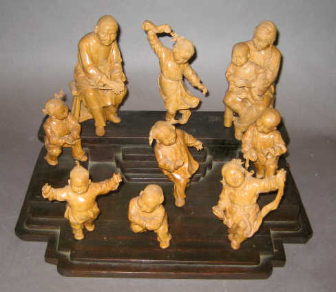 Appraisal: JAPANESE CARVED WOOD FIGURE GROUP Depicting nine individually carved wood