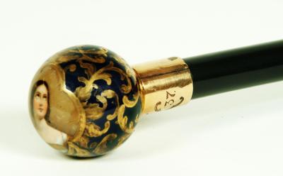 Appraisal: AN EARLY VICTORIAN EBONISED WALKING CANE the Continental porcelain pommel