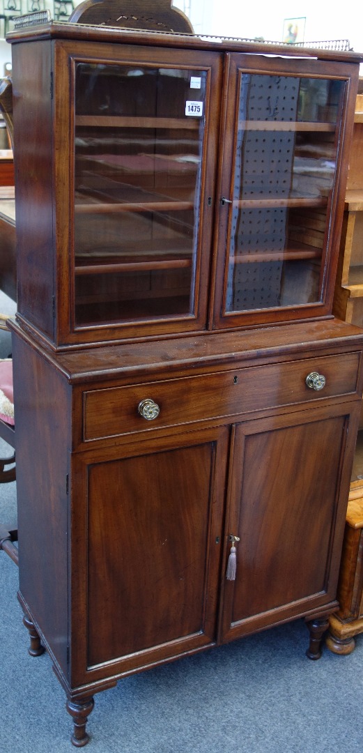 Appraisal: A small th century mahogany bookcase cabinet the pair of