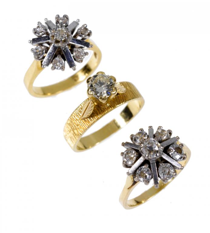 Appraisal: TWO SIMILAR DIAMOND SEVEN-STONE RINGS AND A DIAMOND SOLITAIRE RING