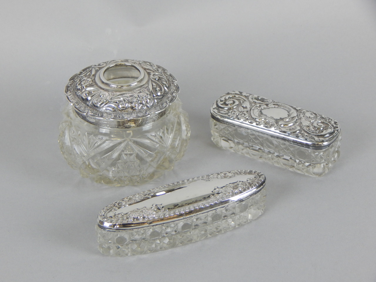 Appraisal: A collection of three cut glass and silver mounted dressing