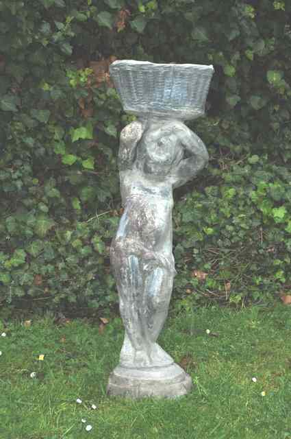 Appraisal: AN ANTIQUE LEAD FIGURE of a boy holding a basket