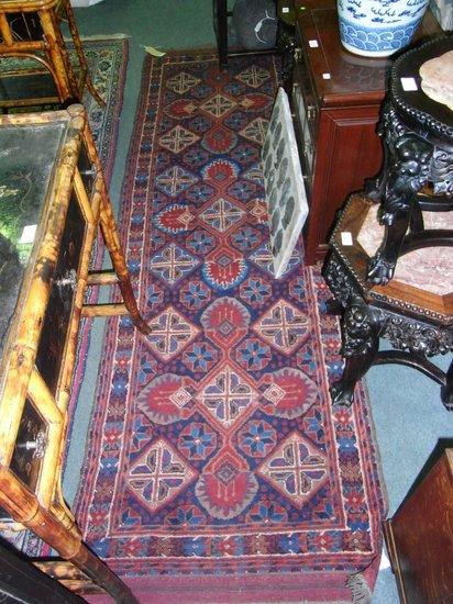 Appraisal: A PAKISTAN BLUE GROUND ORIENTAL STYLE RUG with geometric foliate