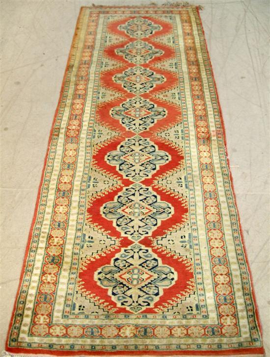 Appraisal: Red ground Persian runner geometric decorative borders and a central