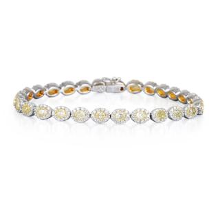 Appraisal: A White and Yellow Diamond Tennis Bracelet Featuring oval-cut yellow