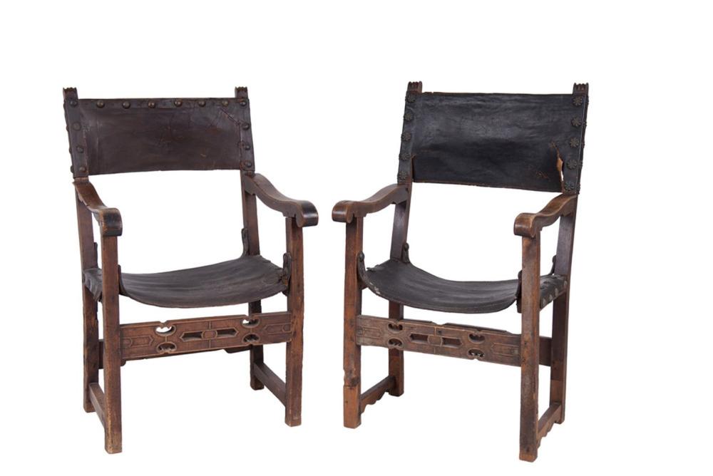 Appraisal: PAIR OF SPANISH WALNUT LEATHER ARMCHAIRSCondition with damage and repair