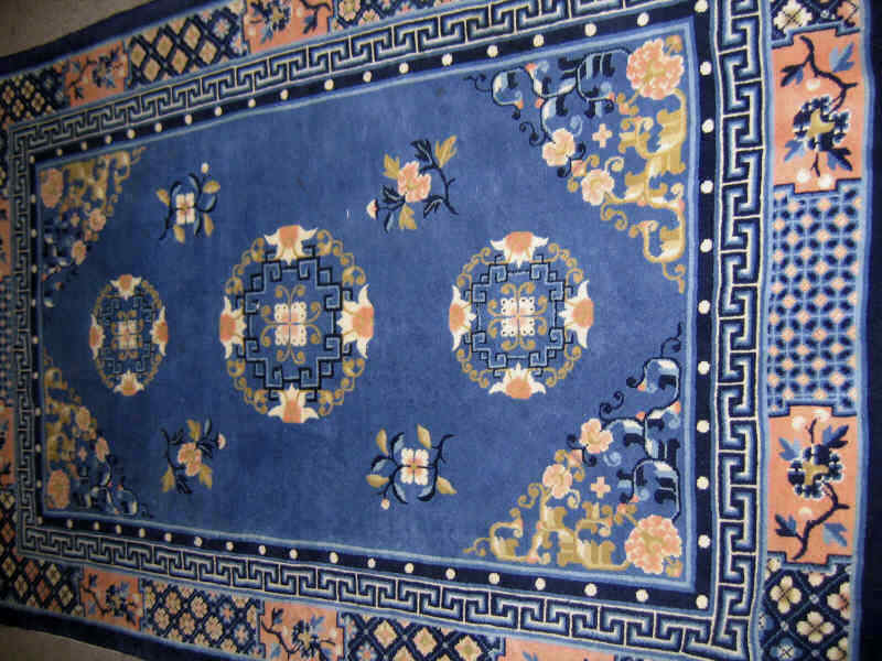 Appraisal: CHINESE THROW RUG The pale blue field centers a row