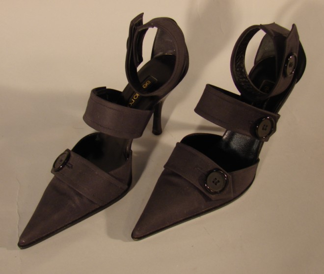 Appraisal: These black fabric ankle strap heels are accented with large