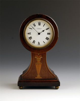 Appraisal: A mahogany and marquetry balloon cased mantel clock with a