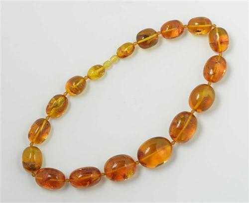 Appraisal: AMBER NECKLACE Decorative necklace of graduated amber olives of ca