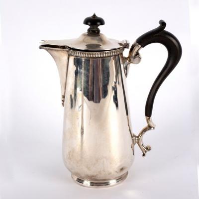 Appraisal: A silver hot water jug Sheffield initialled H with ebonised