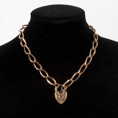 Appraisal: A ct gold chain with a heart-shaped padlock clasp chain