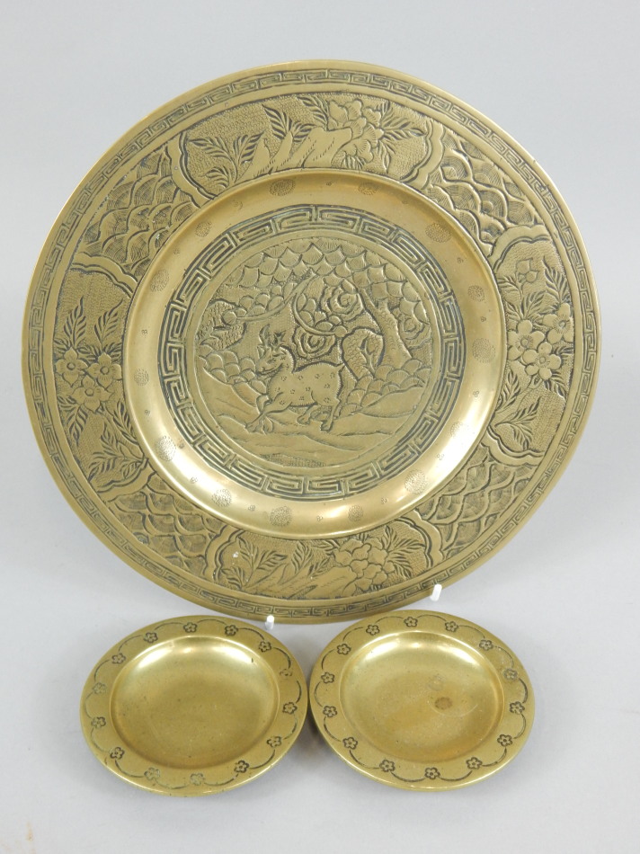 Appraisal: An oriental bronze plate decorated with flowers etc and two