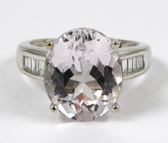 Appraisal: KUNZITE DIAMOND AND FOURTEEN KARAT GOLD RING centering an oval-cut