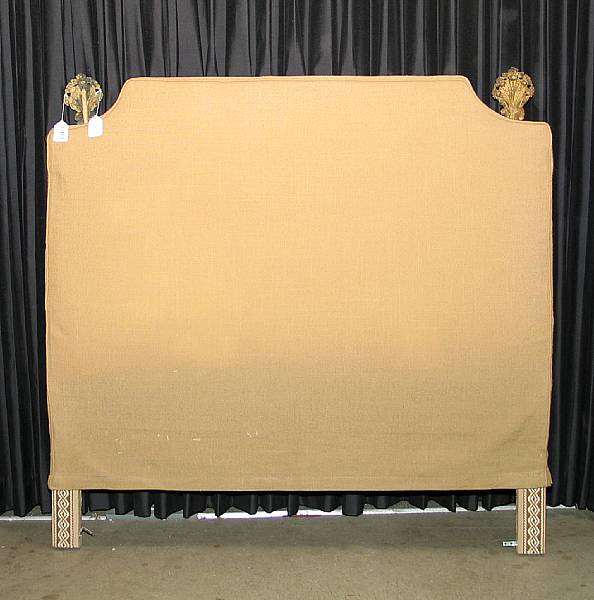 Appraisal: A contemporary upholstered headboard th century with brass repousse finials