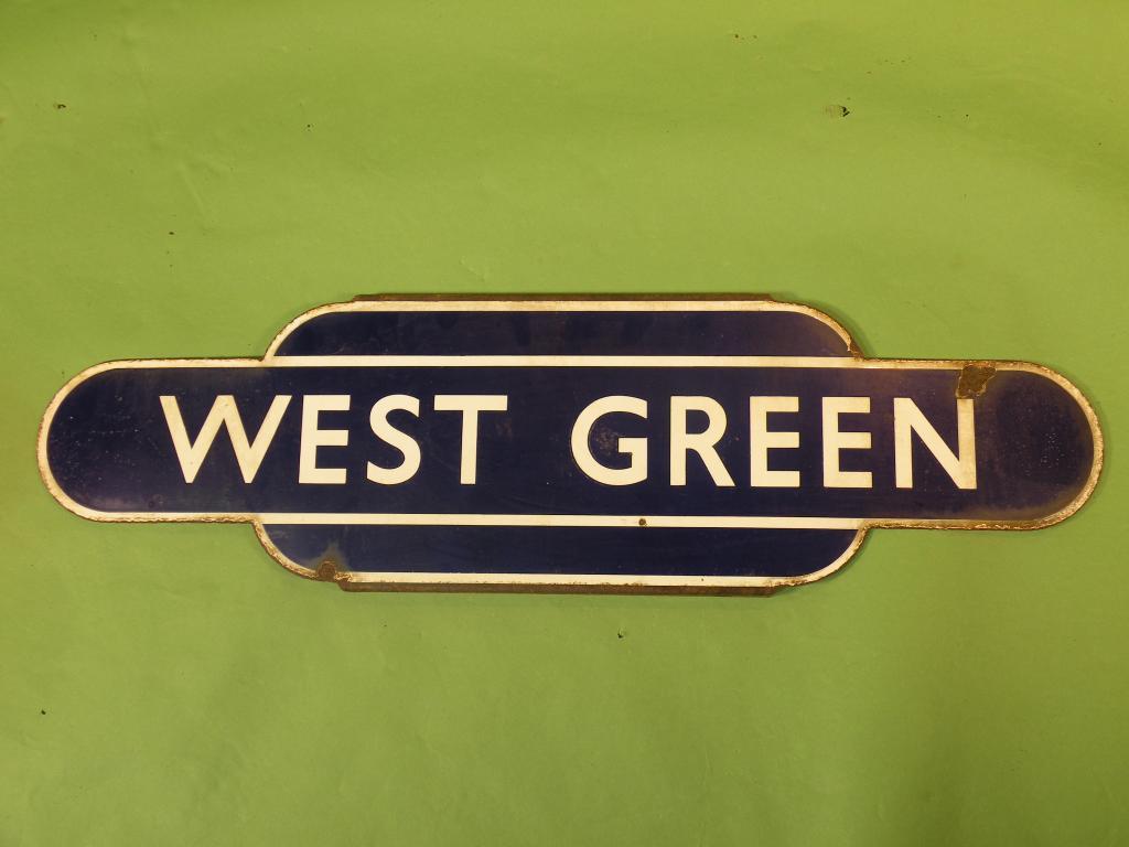 Appraisal: An enamel railway sign West Green with white lettering on