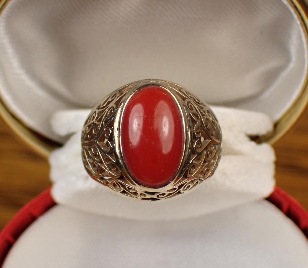 Appraisal: RED CORAL AND FOURTEEN KARAT GOLD RING bezel set with