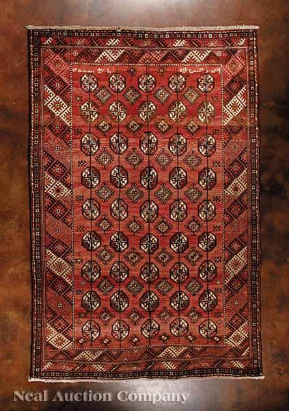 Appraisal: A Persian Turkaman Carpet red ground repeating central field motifs