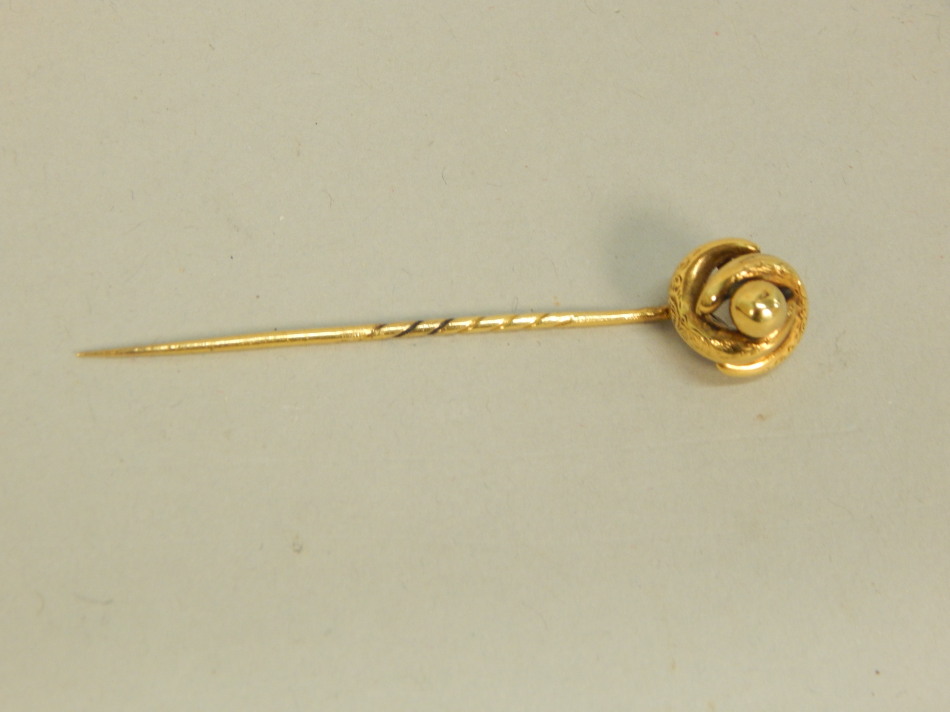 Appraisal: A stick pin of twist and engraved design yellow metal