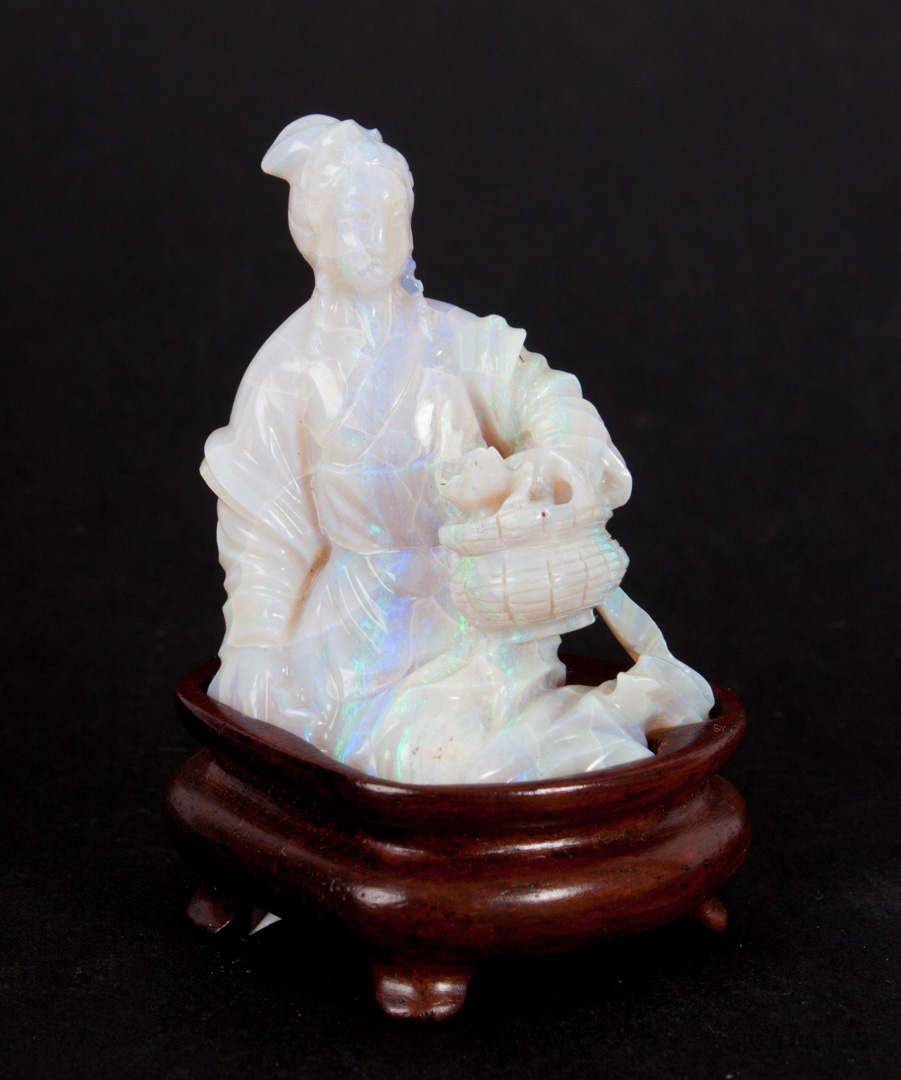 Appraisal: Chinese carved opal figurine modeled as young woman holding flower